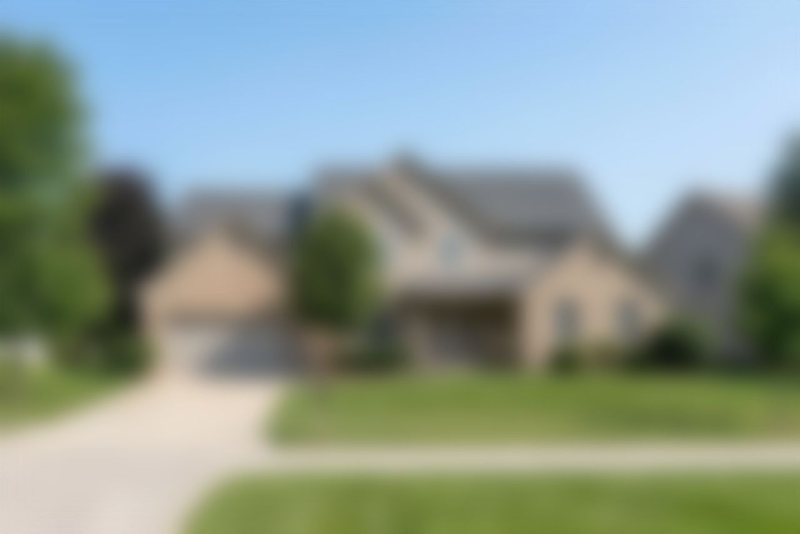 A blurred house, shown for illustration only.